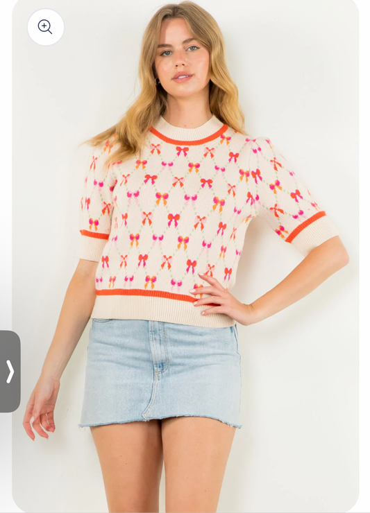 Cream short sleeve knit with orange and pink bows